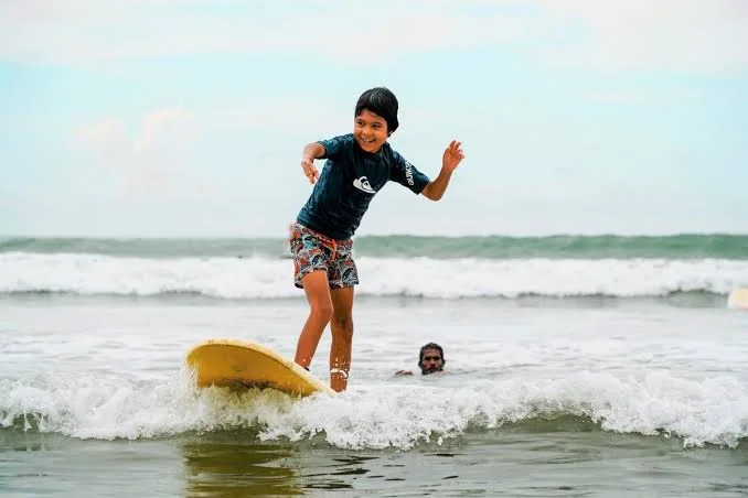 Surfing lesson for a child on a south coast beach